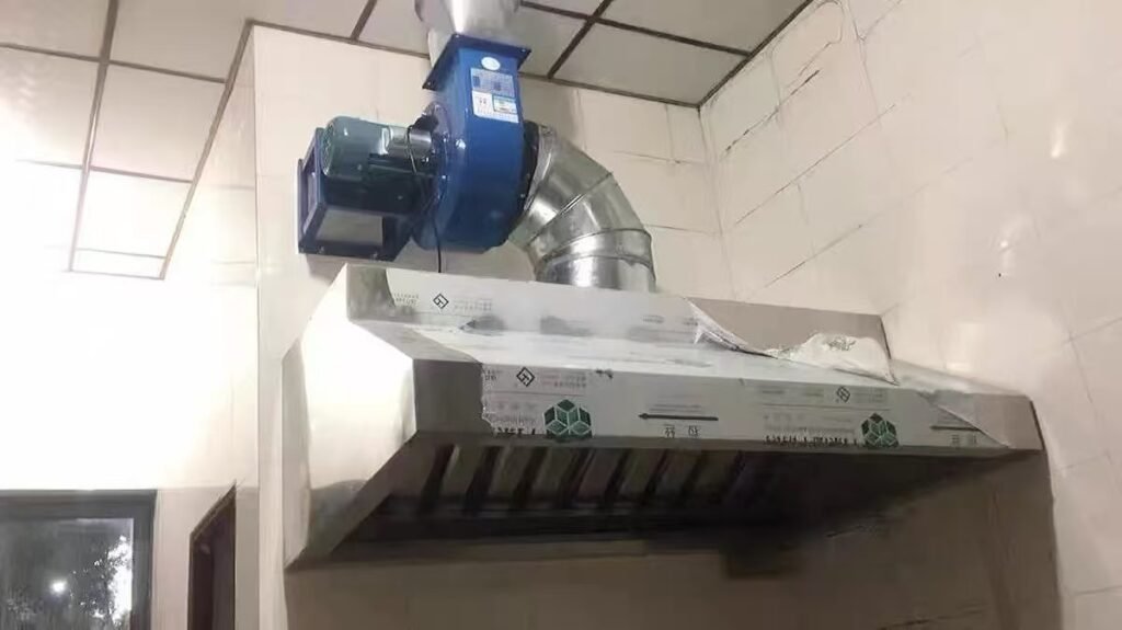 HCF Series backward single-plate kitchen exhaust fan installed over commercial hood for industrial ventilation solutions
