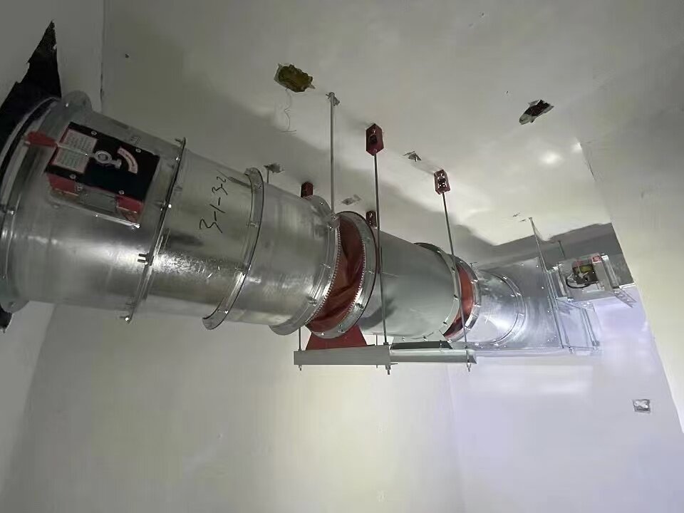 HTF-I Series axial fire exhaust fan installed in ceiling duct for emergency industrial ventilation solutions