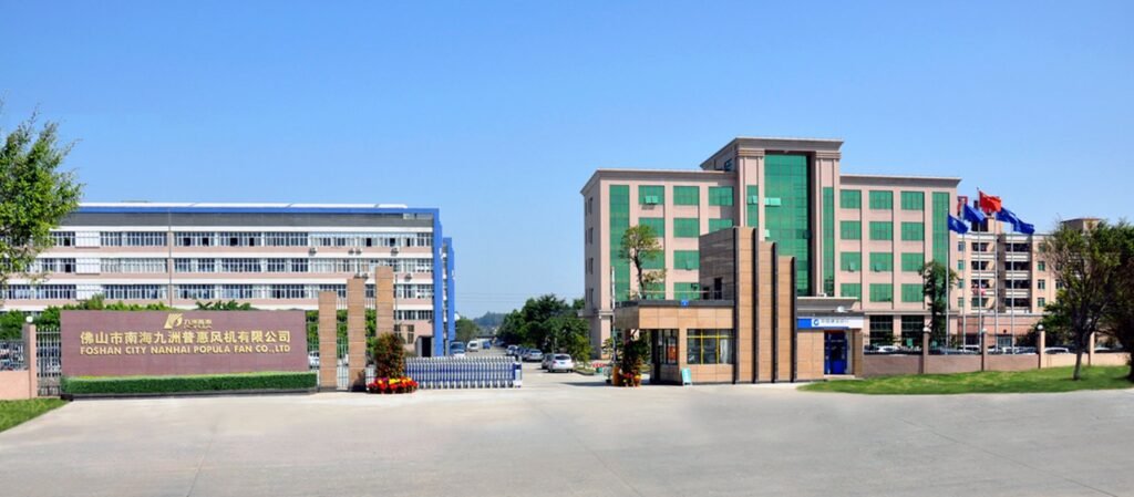 Modern industrial complex featuring multiple office buildings, a prominent Corporate Gate at the entrance, and flags displayed under a clear blue sky.